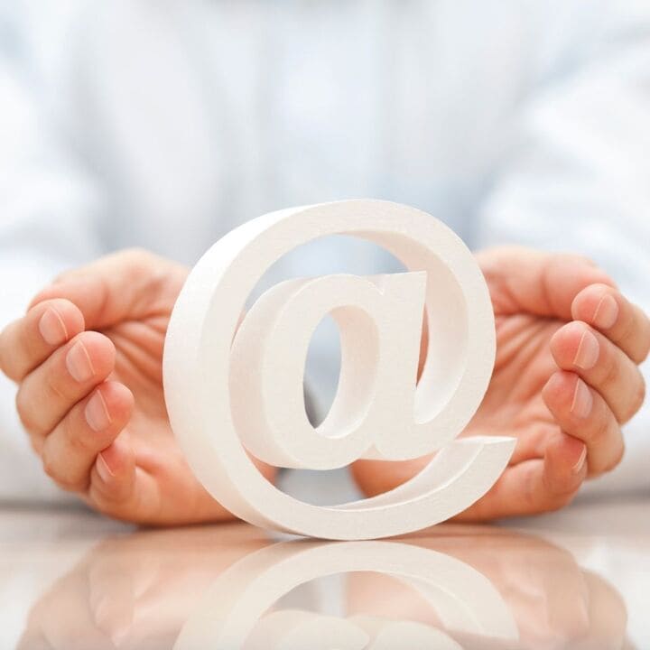 image of two hands cupping the @ symbol 