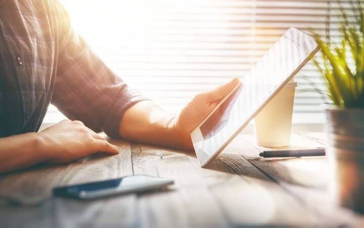 Person looking at a tablet with email marketing information on it