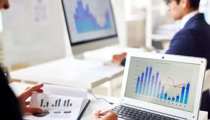 woman looking at a computer scene with bars showing email validation system