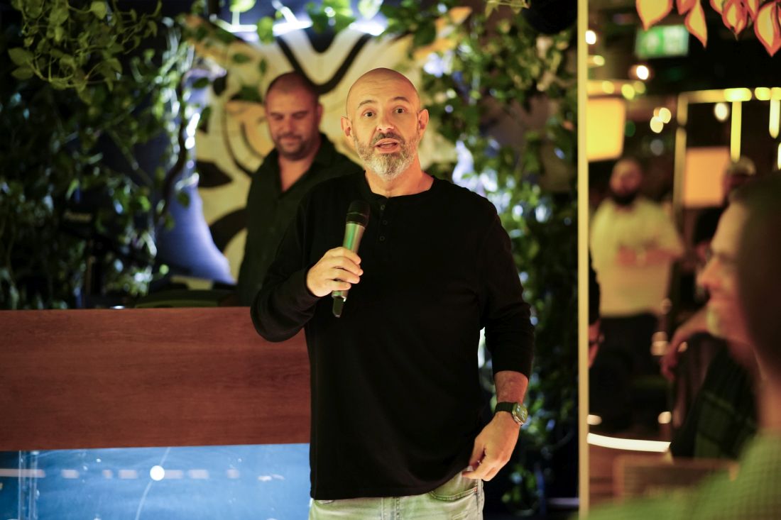 ZeroBounce COO Brian Minick holding a microphone and explaining how X bots would be reduced with email validation and double opt-in