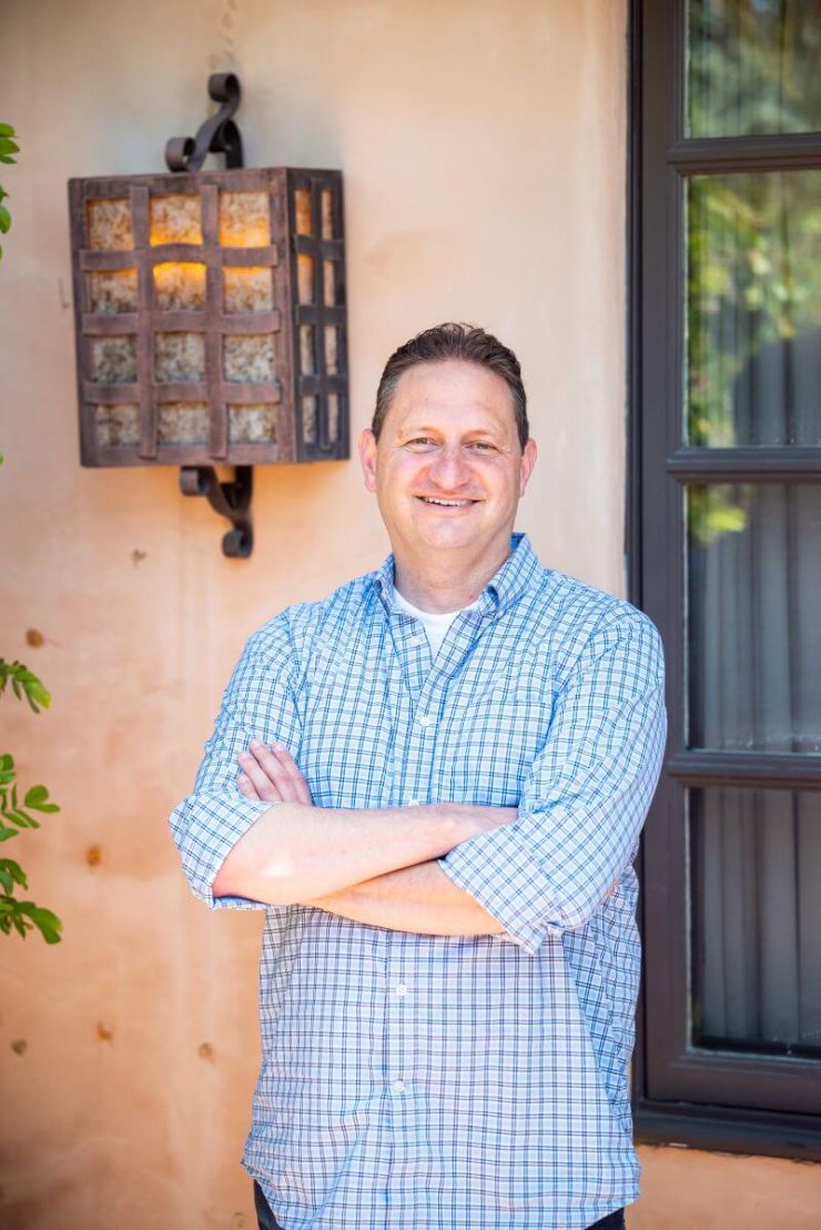 Email expert Josh Spector wearing blue and white shirt and smiling tells ZeroBounce his tactics for monetizing an email newsletter