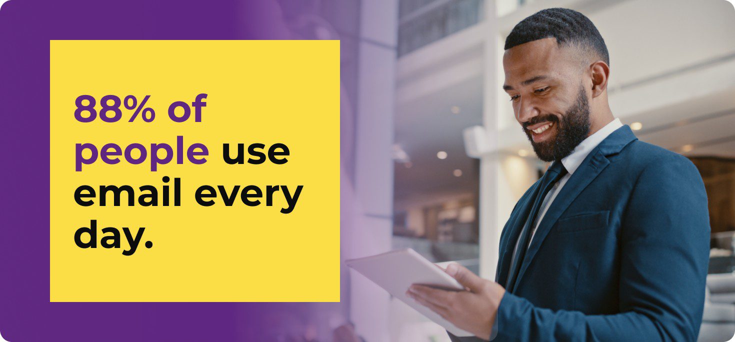 young man wearing suit checking email on tablet with stat from zerobounce email marketing statistics report