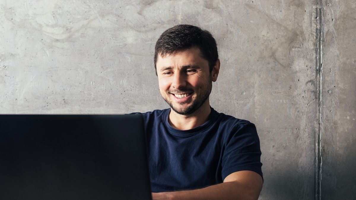 Young man technologist sits before computer to utilize ZeroBounce MCP.